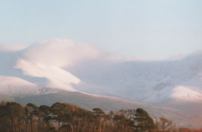 Cloud hanging over snow covered Carneddau Mountains and Ysgolion Duon at 1300 GMT on 10 Feb 2000.
