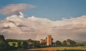 Rainbow beyond Llanidan Church (Anglesey) at 1825 GMT on the evening of the 20 August 2000. Photo: © D. Perkins.