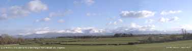 Cumulus clouds over snow-capped Snowdonia. Click for panorama. 