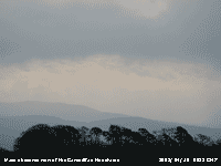 Haze obscures the view of the Carneddau Mountains.