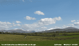 Cumulus clouds over snow capped peaks seen near Bethel.