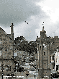 Llangefni and town clock on a mostly cloudy afternoon.