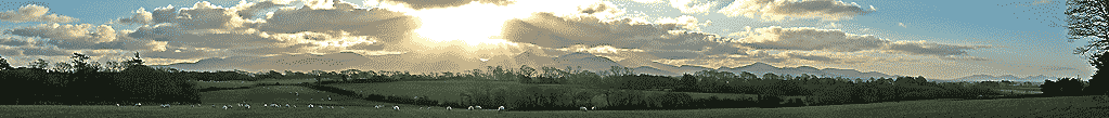 Snowdonia and Lleyn Mountains with crepuscular rays over Nant Ffrancon Pass.
