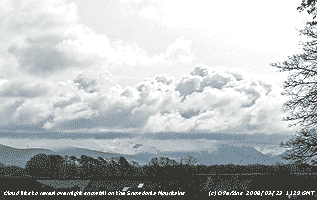 Overnight snowfall revealed as cloud lifts from the mountains.