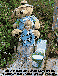 Robert the gardener bear with young gardener at the NSPCC Plant Sale. 