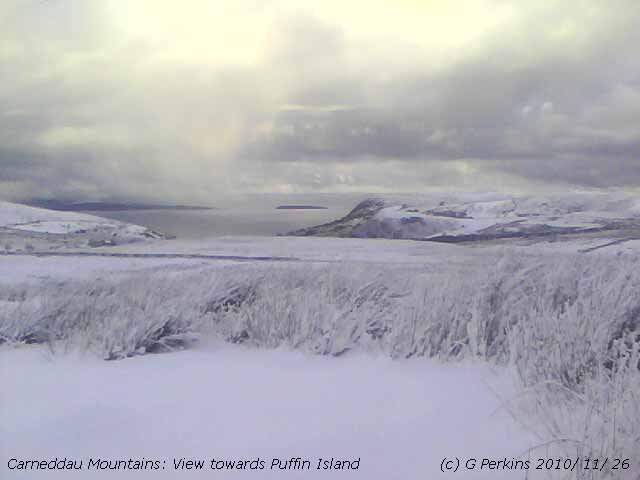 Snow on the Carneddau looking towards Puffin island.