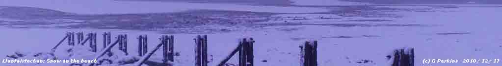 Snow on the beach and Lavan Sands at Llanfairfechan .