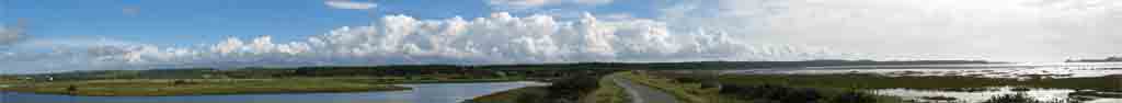 The Cob Malltraeth: Cumulus clouds over Snowdonia with advancing front in the West.