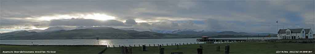 Snow-clad mountains seen from The Green in Beaumaris.