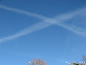 Two contrails to the SE crossing at different heights.