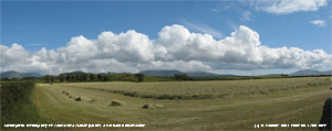 Making hay as convective clouds gather over S Snowdonia.