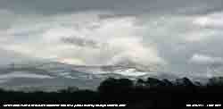 Bare ground showing through old drifted snow on the lower slopes of the Carneddau on 11 April 2013.