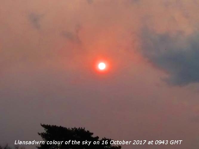 Reddish colour of the sky and sun in Llansadwrn.