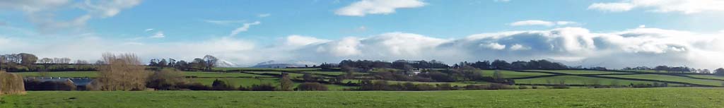 View of snowy Snowdonia from Llansadwrn's sunny lee-break.