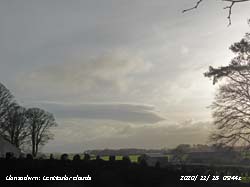 Cumulus and lenticular altocumulus clouds.