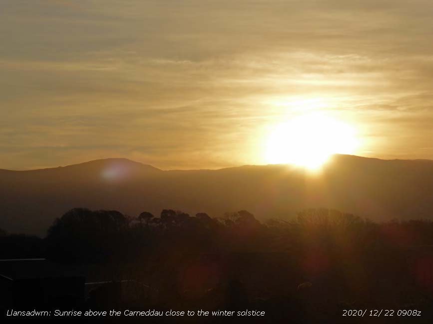 Sun rises above the Carneddau Mountains.