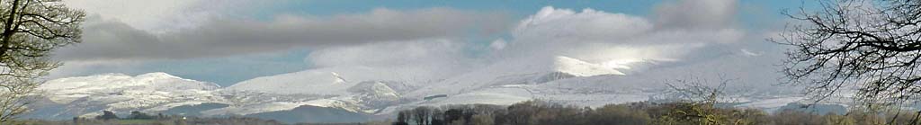 View #StayingAtHome across the water towards the Carneddau covered in snow on the last day of 2020.