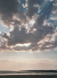 Crepuscular rays as a cumulus cloud dispersed over Aberffraw beach on 23 August 2000; Photo: &copy; D. Perkins.