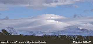 Orographic waves over snow sprinkled Carneddau Mountains.